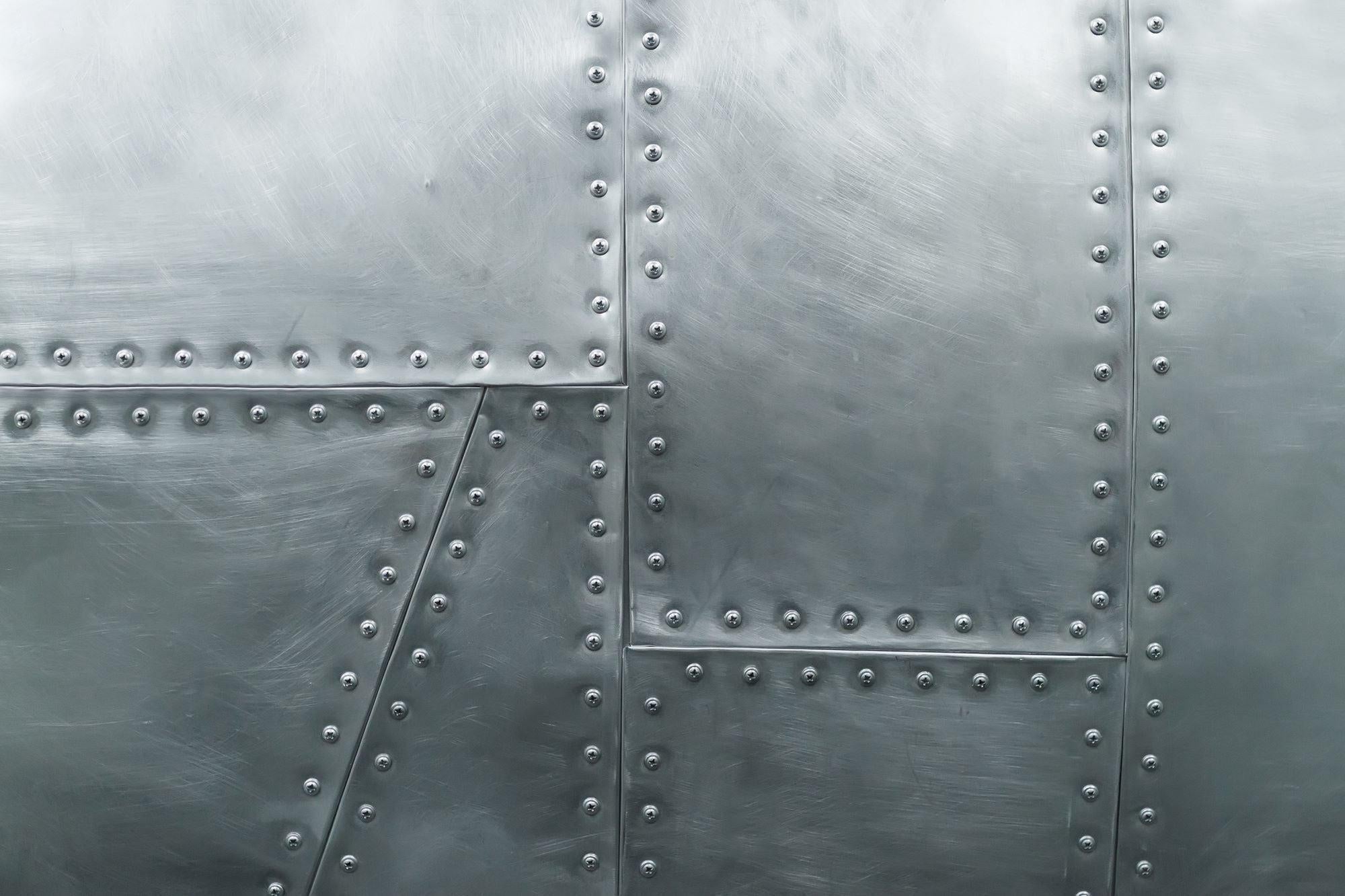 Industrial wallpaper design file showing detailed riveted steel plate pattern and texture