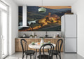 Tuscan villa wallpaper creating a window effect in a modern dining room, warm sunset glow illuminating the space