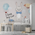 Nursery wall mural with bunny and hot air balloons creating a cozy atmosphere in a modern nursery room