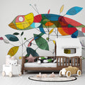 Colorful geometric chameleon wallpaper brightening a modern kids bedroom with white furniture and playful accessories