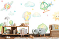Hot air balloon nursery wallpaper shown in bright kids bedroom with white furniture and playful accents