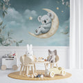 Koala nursery wallpaper creating a peaceful atmosphere in a modern white nursery with wooden furniture