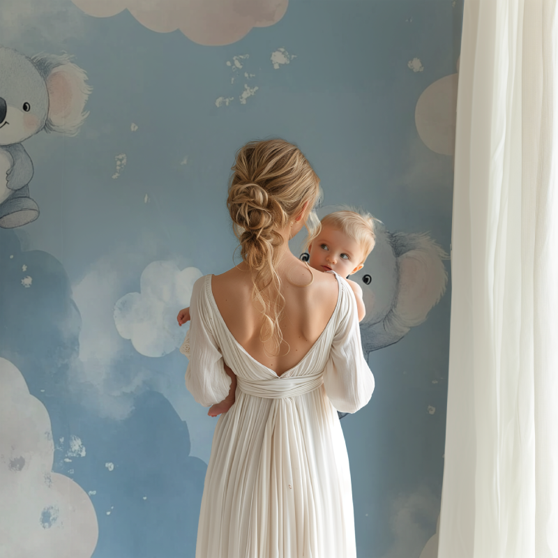 Nursery wall mural featuring koalas installed behind a white crib