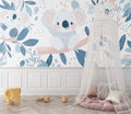 Koala nursery wallpaper creating a peaceful atmosphere in a modern white nursery with natural wood furniture