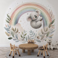 Koala nursery wallpaper creating a soft, dreamy atmosphere in a modern white nursery with natural wood furniture