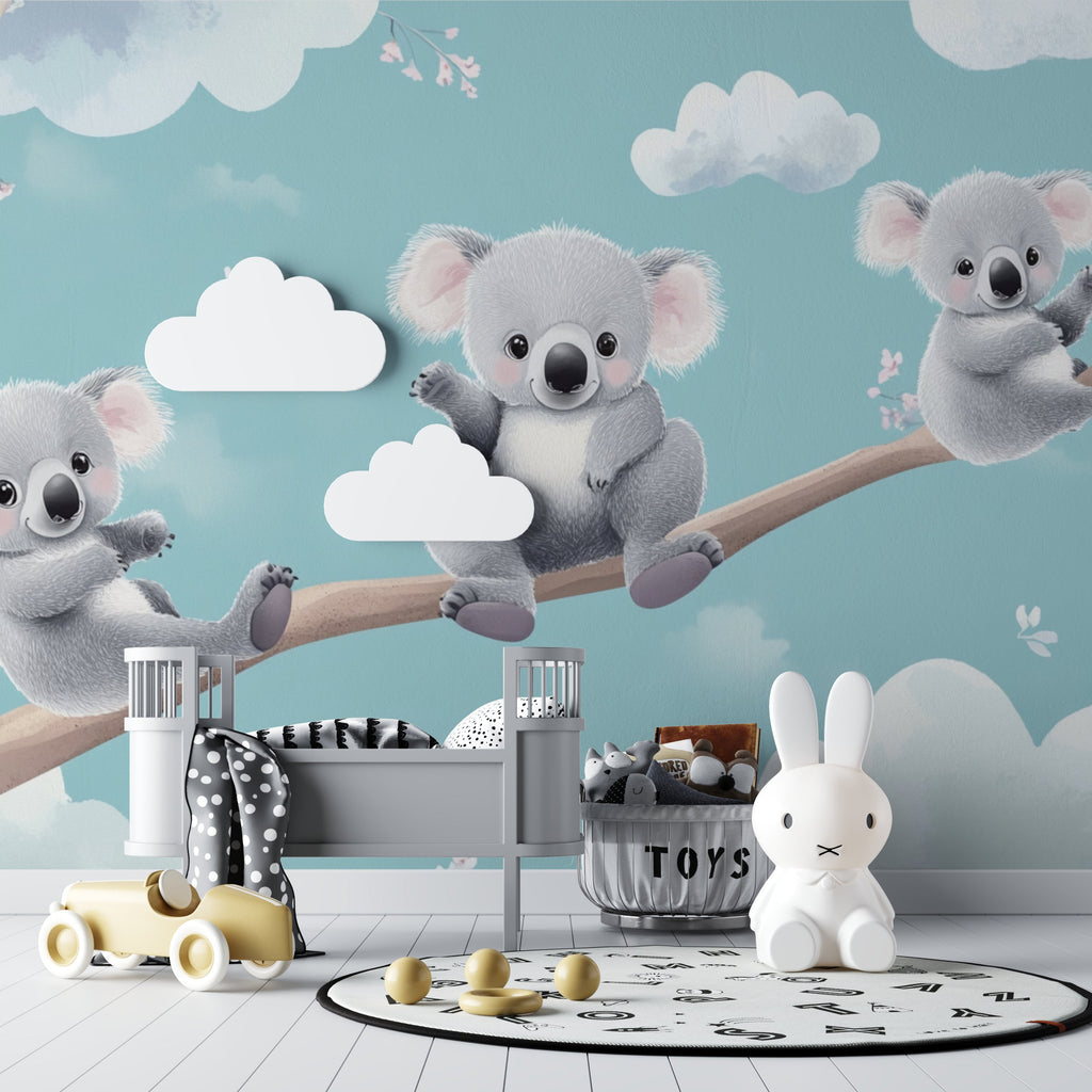 Nursery wall with koala wallpaper design next to changing table and mobile