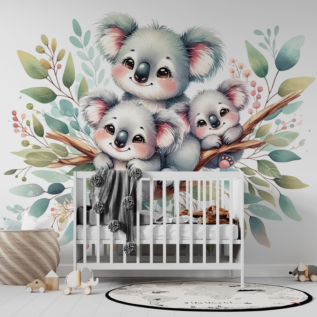 Koala family wallpaper mural in a bright nursery setting, showing three cute koalas among watercolor leaves