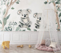 Koala wallpaper mural in a bright nursery with white furniture