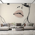 Line art portrait wallpaper creating a bold statement in a modern living room with white furniture and natural light