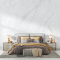 White marble wallpaper mural styled in modern minimalist living room showing subtle grey veining