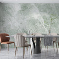 Green marble wallpaper creating luxury atmosphere in modern living room with natural light