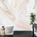 Pink and gold marble wallpaper creating an elegant backdrop in a modern living room with clean furniture