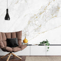 White and gold marble wallpaper creating luxury atmosphere in modern living room with natural light