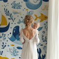 Marine animals wallpaper displayed in a bright nursery with white furniture, showing playful whales and boats