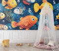 Marine fish wallpaper in bright kids bedroom showing colorful fish swimming against deep blue background