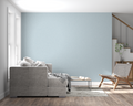Powder blue minimalist wallpaper in modern living room with natural light streaming through windows