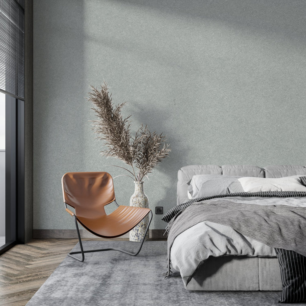 Minimalist grey textured wallpaper in modern living room with natural light highlighting subtle surface details