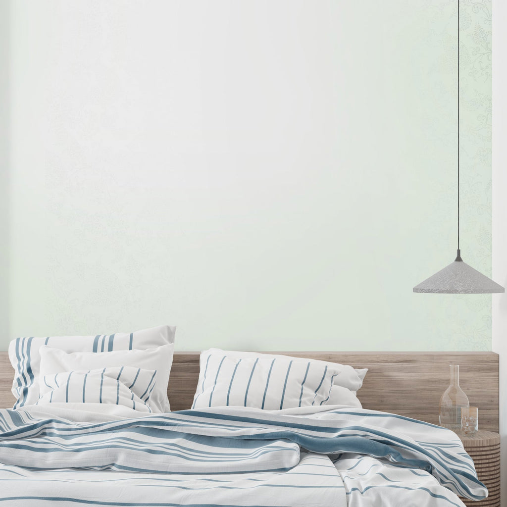 Soft green wallpaper in home office showing clean minimal aesthetic