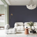 Modern grey wallpaper creating a sophisticated living room with leather sofa and minimalist decor