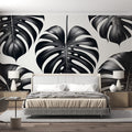 Modern black and white Monstera leaf wallpaper creating a striking focal point in a minimalist living room setting