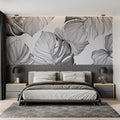 Modern Monstera leaf wallpaper in a bright Scandinavian living room showing the dramatic black and white pattern