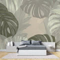 Monstera leaf wallpaper creating a fresh vibe in a modern living room with white furniture