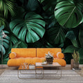Monstera leaf wallpaper creating a bold statement in a modern living room with minimalist furniture