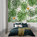 Monstera leaf wallpaper creating a fresh atmosphere in a modern living room with natural light