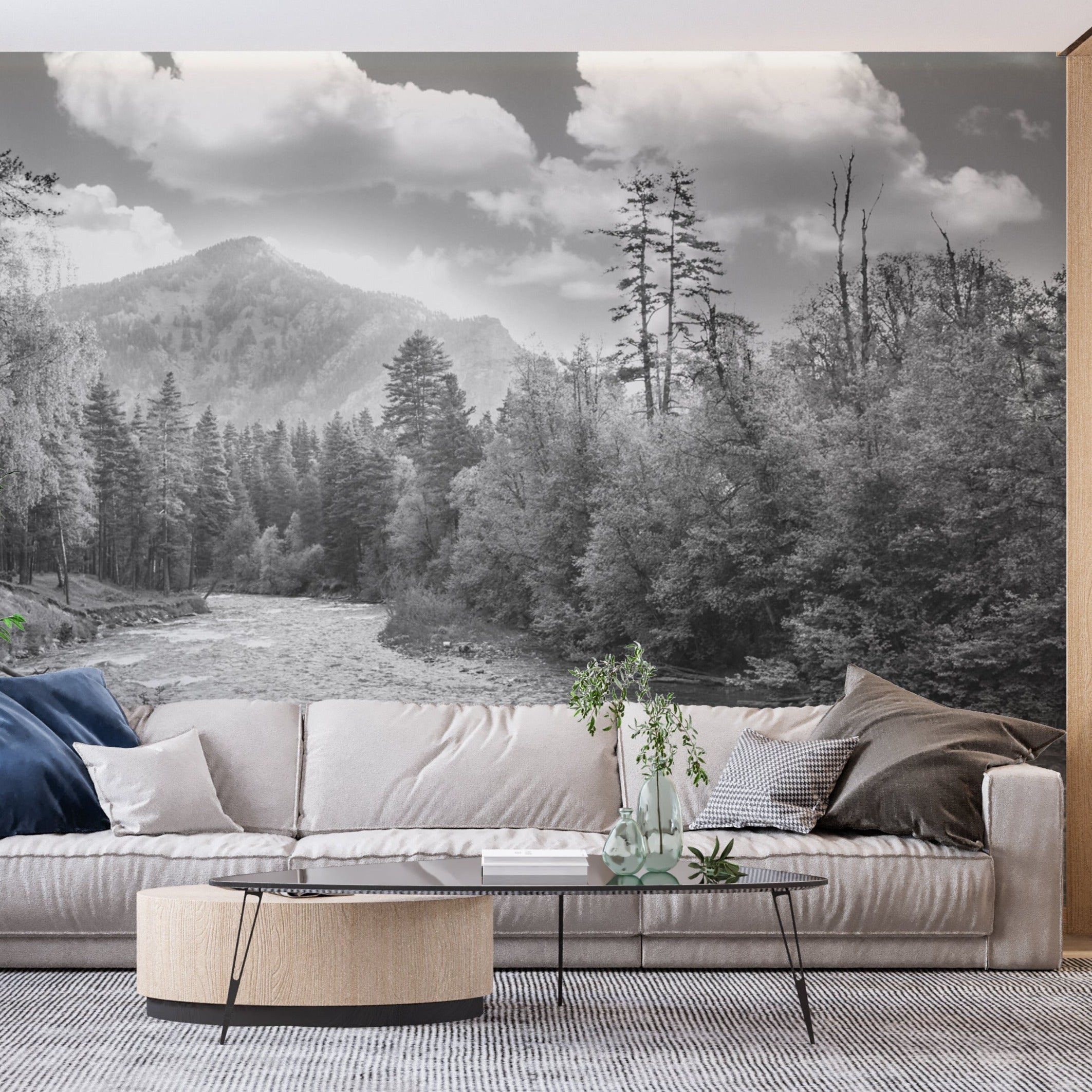 Black and white mountain landscape mural in modern living room showing dramatic river scene with pine trees