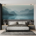 Mountain lake wallpaper creating depth in modern living room with grey sofa