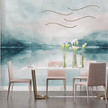 Mountain lake wallpaper mural creating depth in modern living room with grey sofa