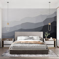 Modern geometric mountain wallpaper with gradient design shown in a minimalist living room with natural light