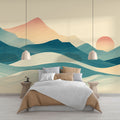 Mountain mural wallpaper with abstract sunset waves design shown in a modern living room setting with minimal furniture