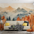 Mountain landscape wallpaper with autumn forest colors shown in a bright modern living room with minimal furniture