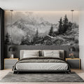 Mountain mural wallpaper creating depth in a modern living room, black and white alpine peaks above grey sofa