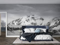 Mountain wall mural creating depth in modern living room with grey sofa and natural light