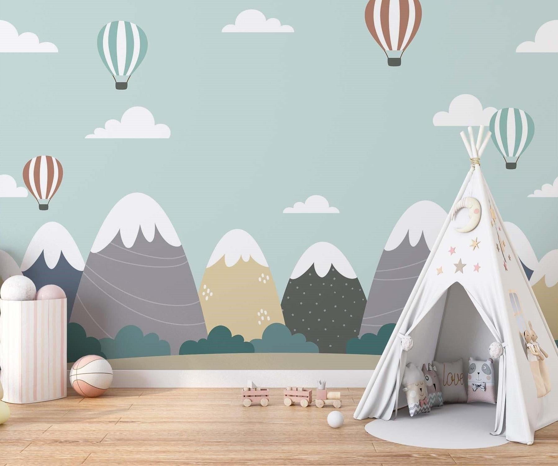 Mountain and hot air balloon wallpaper in a bright modern nursery with white furniture