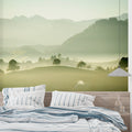 Mountain landscape wallpaper creating depth in a modern living room with grey sofa and natural light