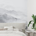 Mountain landscape wallpaper creating depth in modern living room with grey sofa and minimal decor