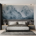 Mountain landscape wallpaper creating depth in modern living room with grey sofa and natural light