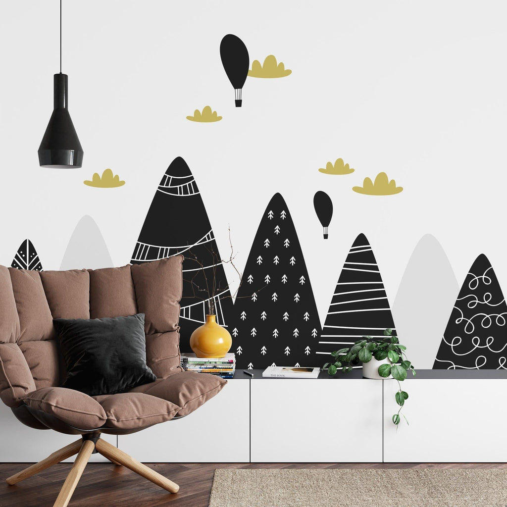 Black and gold mountain wall mural creating depth in a modern home office with wooden accents