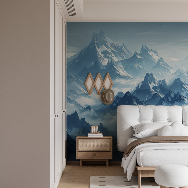 Mountain peak wallpaper creating depth in modern living room with grey sofa and natural light