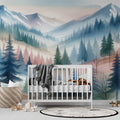 Mountain landscape wallpaper creating depth in a modern living room, soft morning light highlighting the watercolor pine forest design