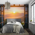 Mountain sunset mural wallpaper creating depth in modern living room with grey sofa