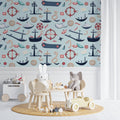 Nautical wallpaper in bright kids bedroom with white furniture showing playful ships and compass design