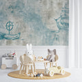 Nautical wallpaper with vintage ships in a cozy nursery setting, soft blue-grey tones create a peaceful atmosphere
