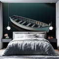 Nautical wall mural with wooden boat creates a stunning focal point in a modern living room with minimal furniture