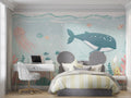 Ocean animals wallpaper displayed in a bright nursery with soft lighting and wooden furniture