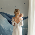 Whale nursery wallpaper creating a peaceful atmosphere in a modern nursery with white furniture