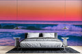 Ocean wave wallpaper creating a serene atmosphere in modern living room with sunset colors